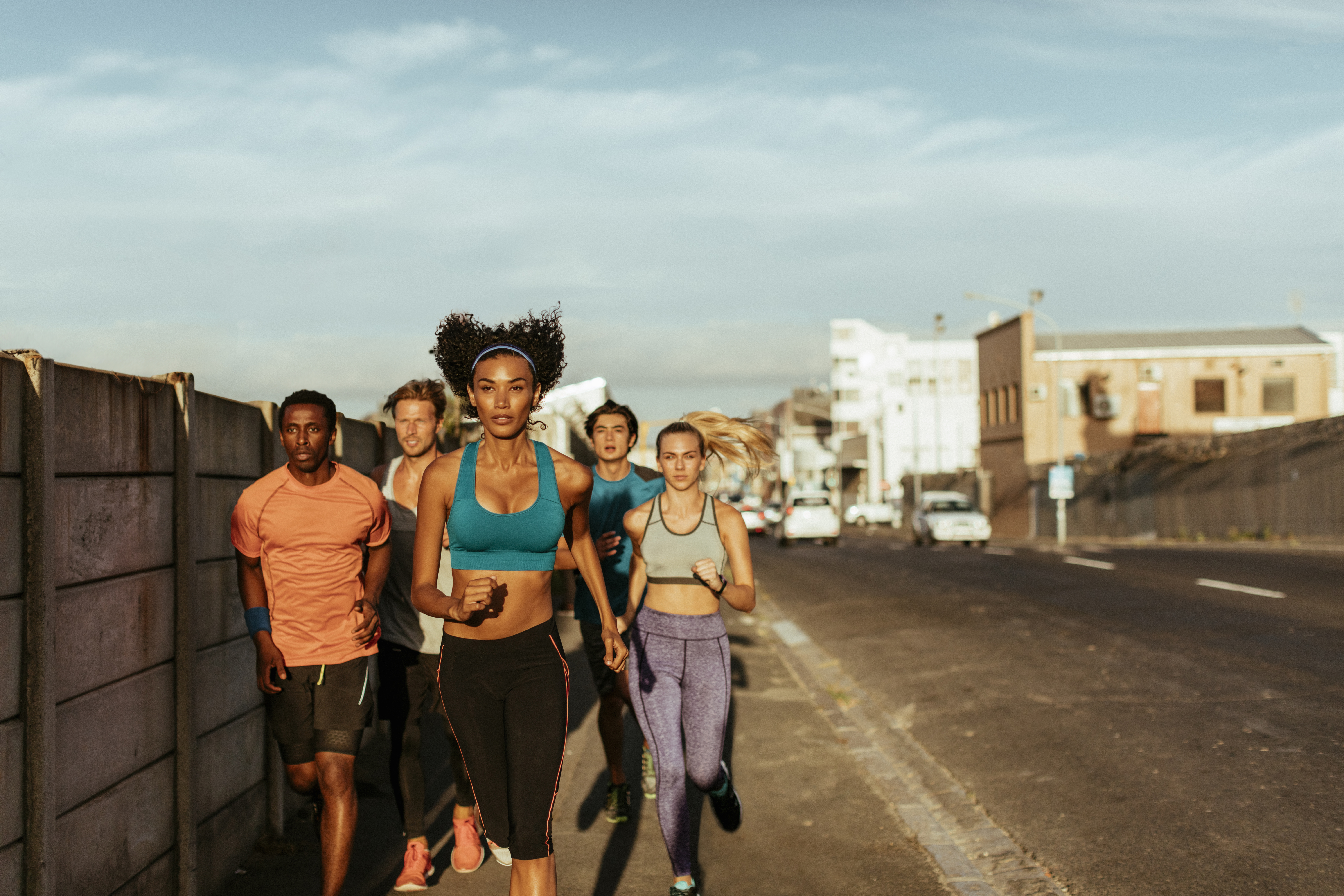 Close up of friends jogging